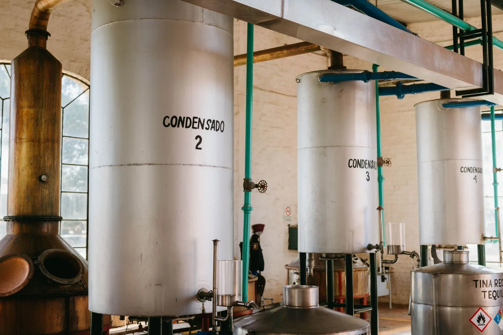 Industrial distillery with condensers and stainless tanks