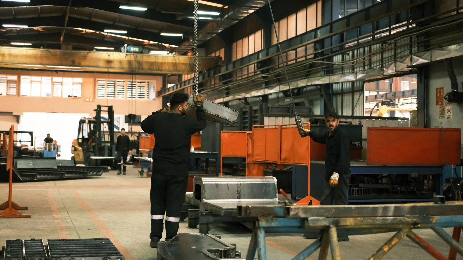 Workers operating machinery in a heavy engineering factory