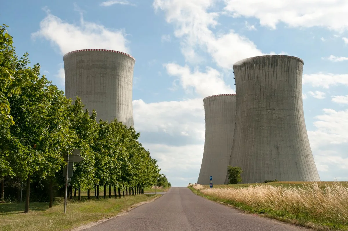 Nuclear power station cooling towers beside a road